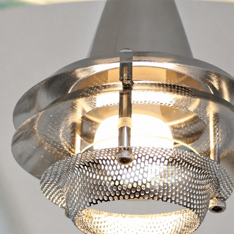 Illuminated glass and metal detail of the Moxellan pendant light