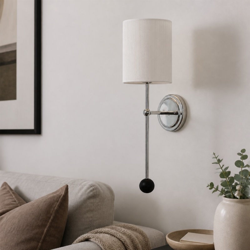 Cumoris pleated wall lamp beside a sofa