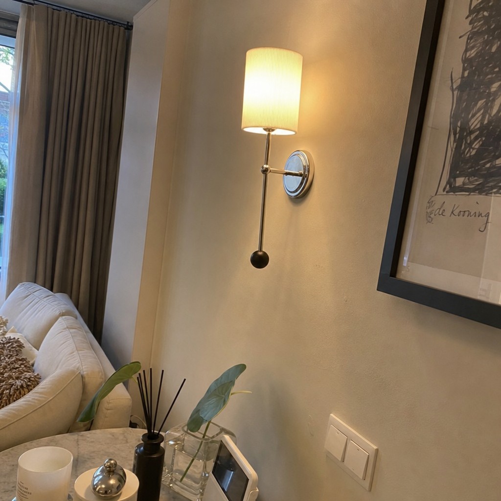 Customer photo of the lit wall sconce beside a sofa